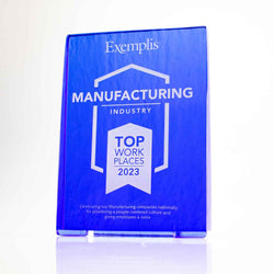 Vibrant recycled glass awards in deep cobalt blue and emerald green, with sandblast engraving